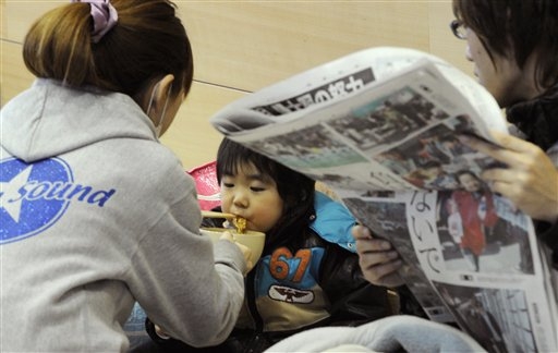 japanese mother feeds child fukushima shelter